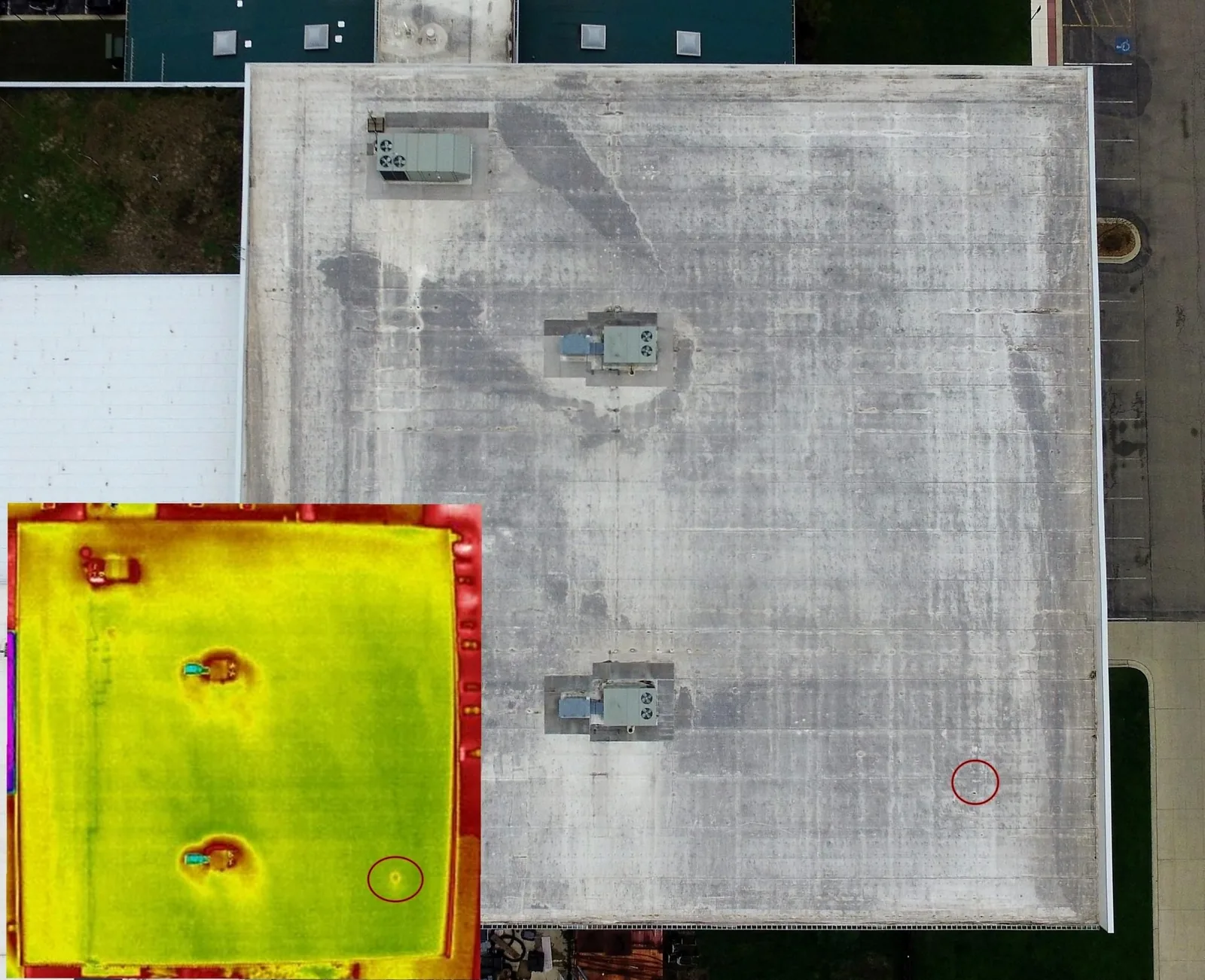Aerial view of a commercial flat roof with a thermal overlay showing heat signatures on the roof surface