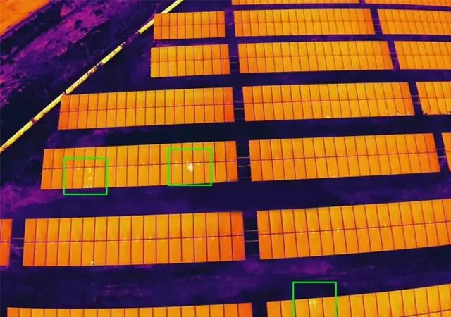 Thermal aerial image of a solar panel array with hot spots and faulty cells highlighted